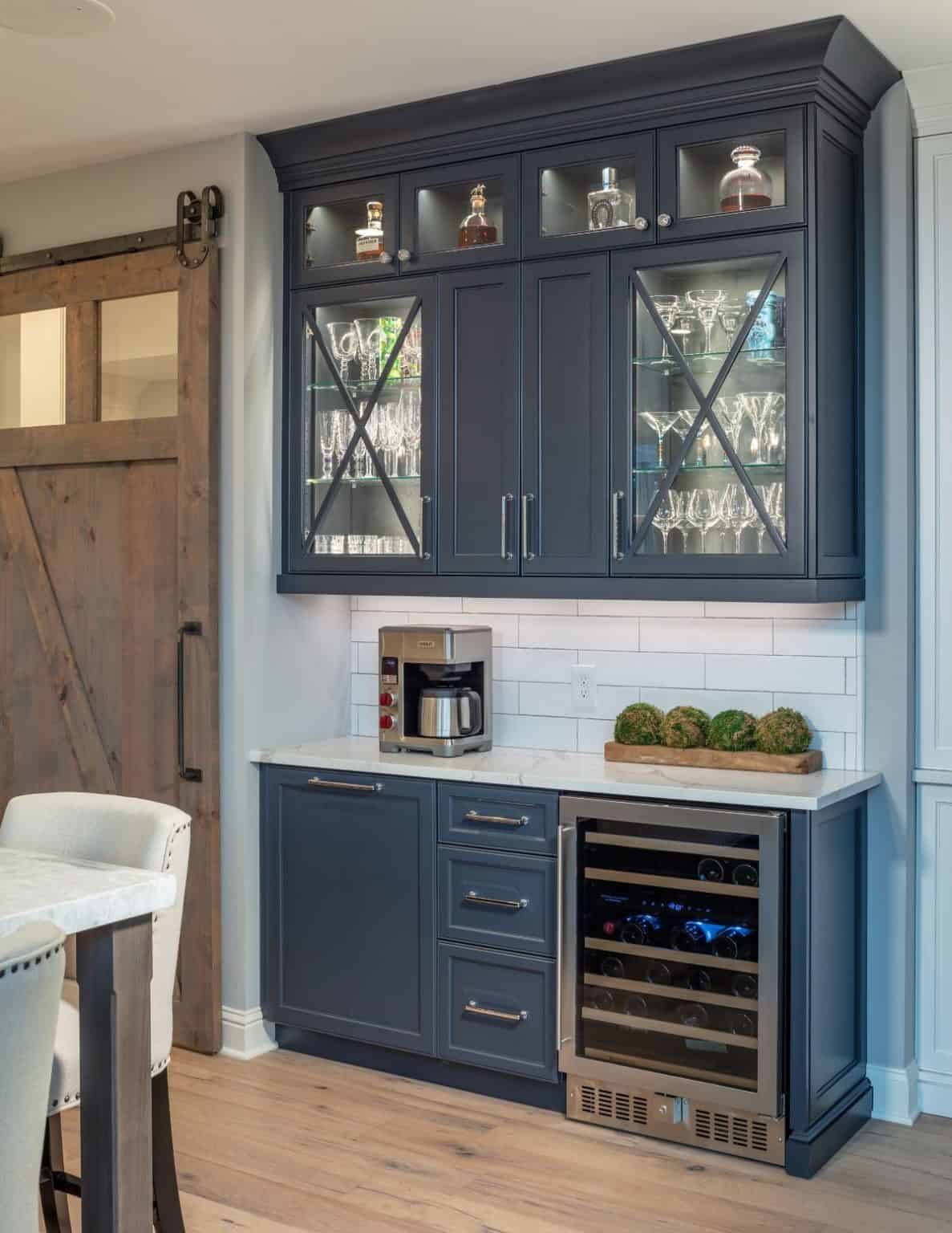 Bar with blue cabinets and barn door in Snapper Creek
